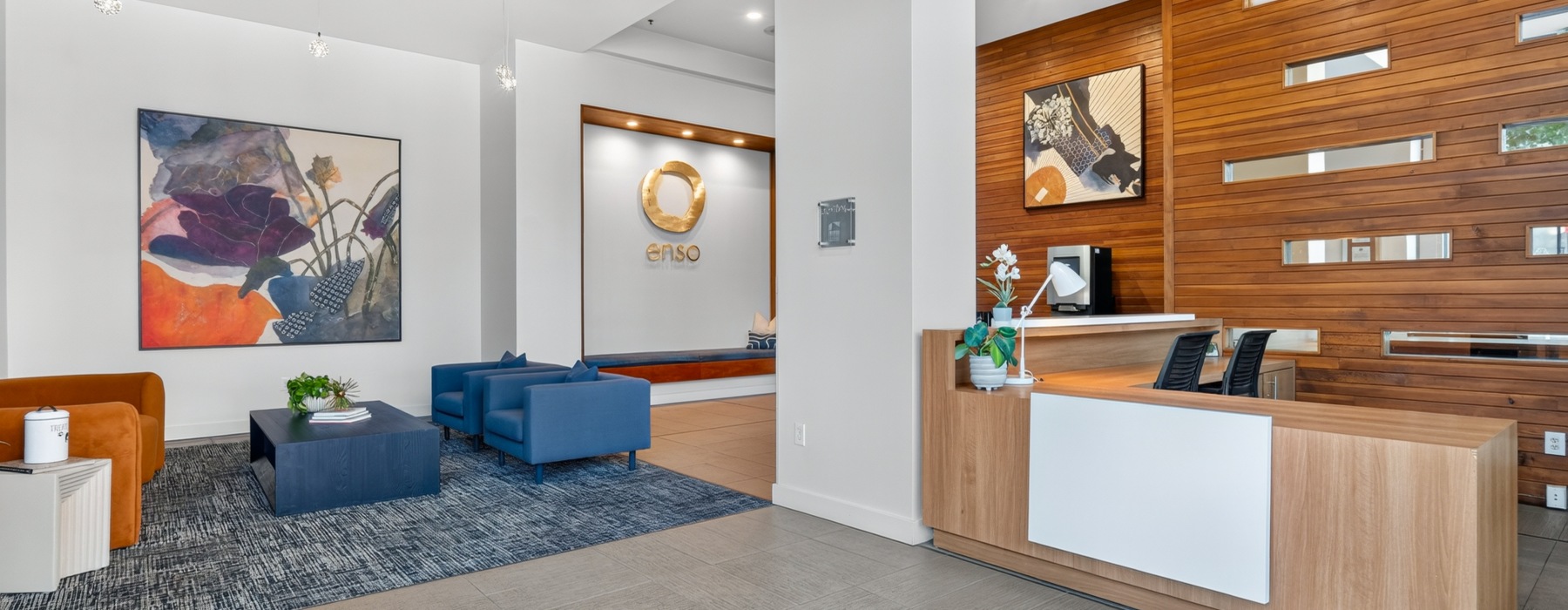 a lobby with a couch and chairs and office desk