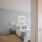a bedroom with a bed and a lamp